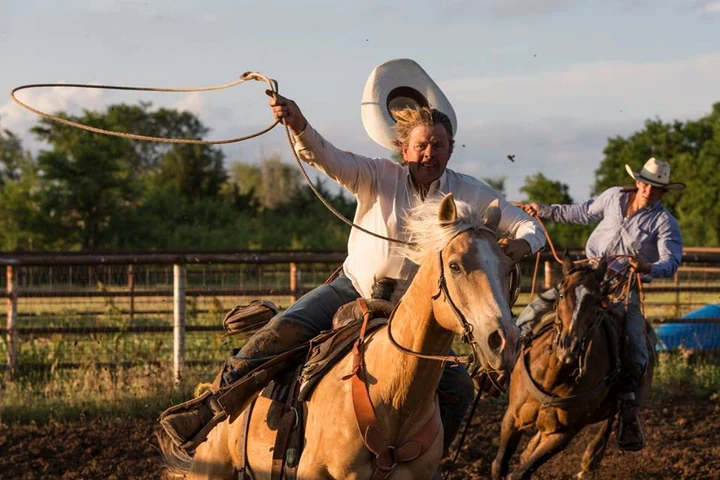 Riders and horses in warm evening light, from Three Wooden Crosses Cowboy Church’s public photo gallery.